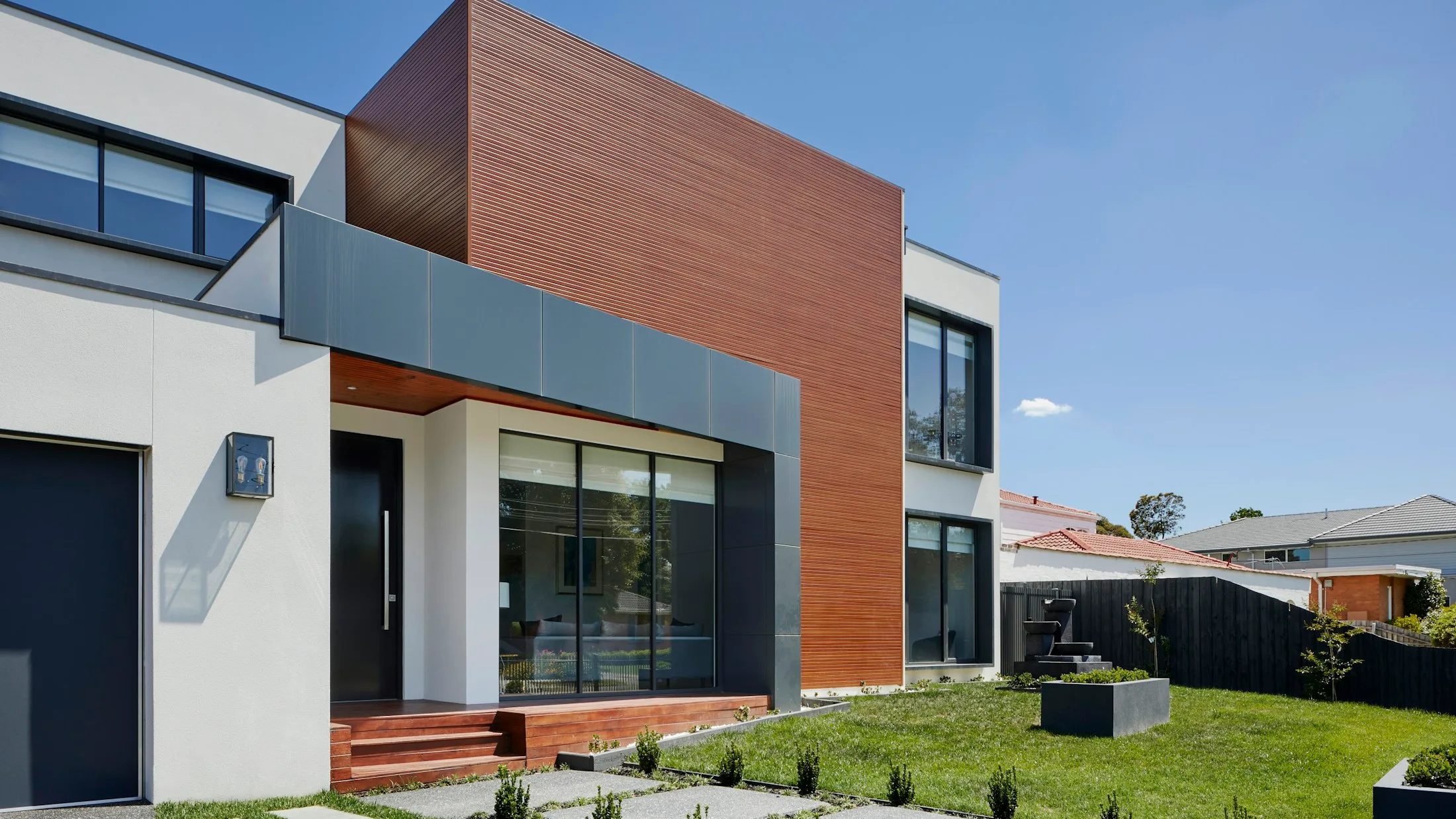 Bright modern South Florida home exterior with clean driveway and landscaping